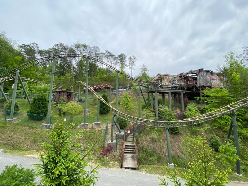 Guide To Dollywood, fire chaser rollercoaster with red carts going backwards along the track