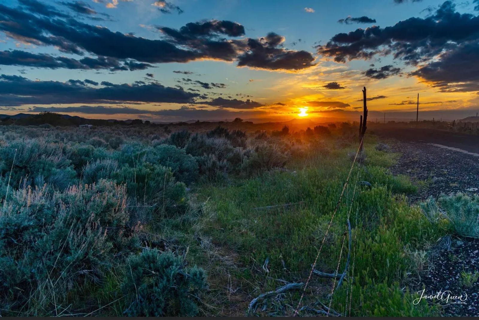 beautiful colorful sunset over a feild of green sage