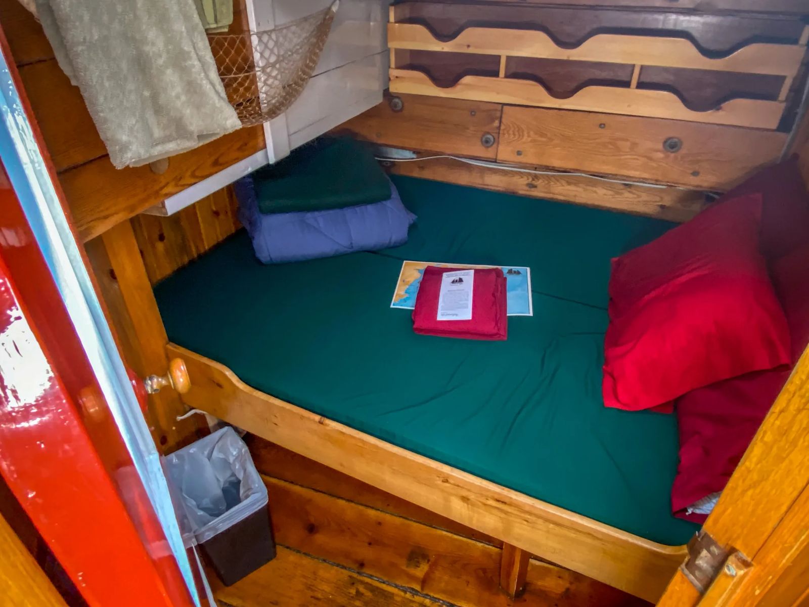 A bunk bed in the Ships cabin with mattress and bedding and pillows