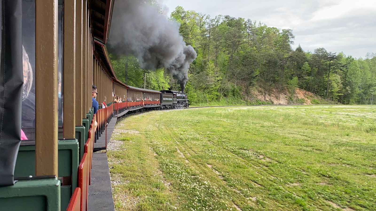 Dollywood Express and Klondike Kate along the tracks with a plum of black smoke from its engine