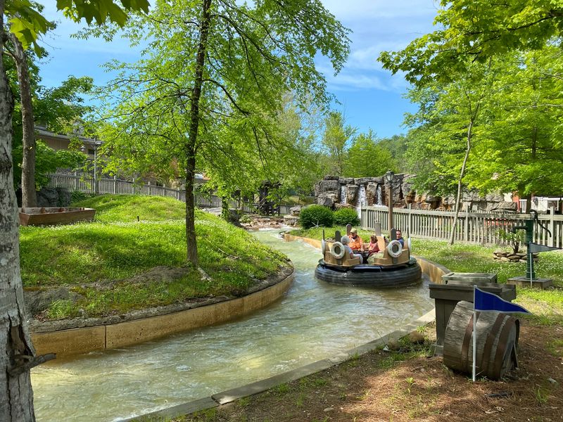 Guide to Dollywood, a family floats along a winding river ride