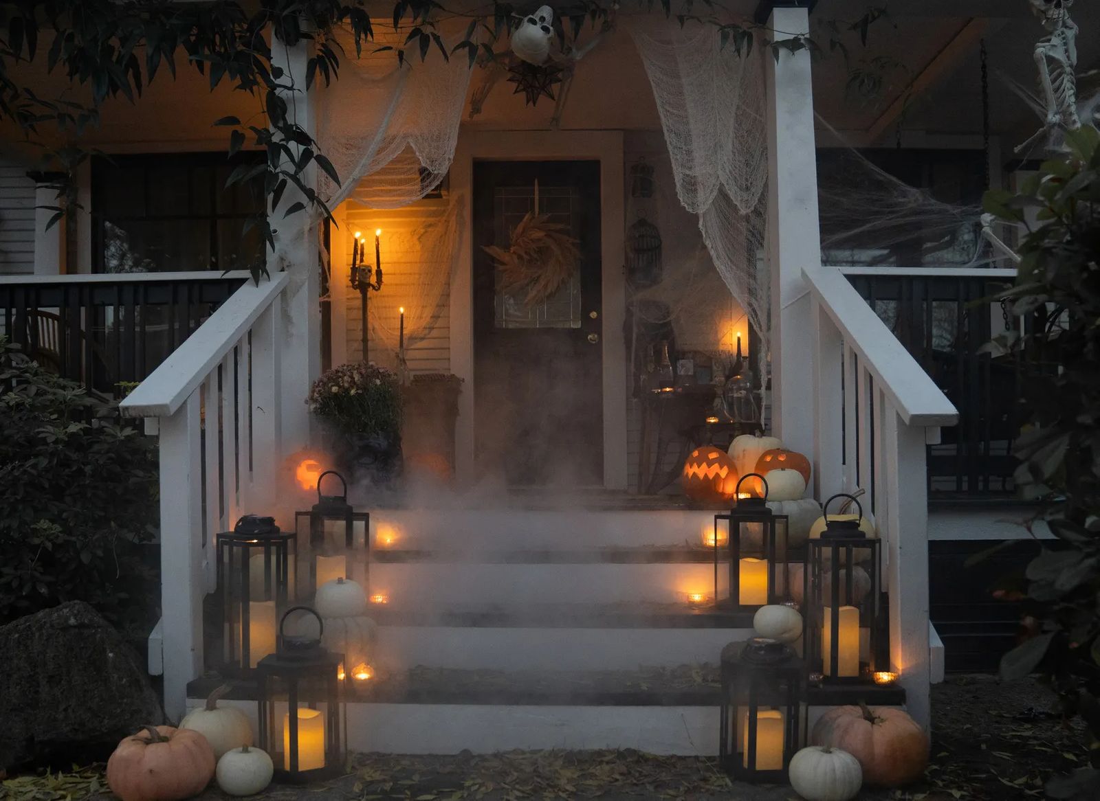 professionally decorated house porch for halloween with mist