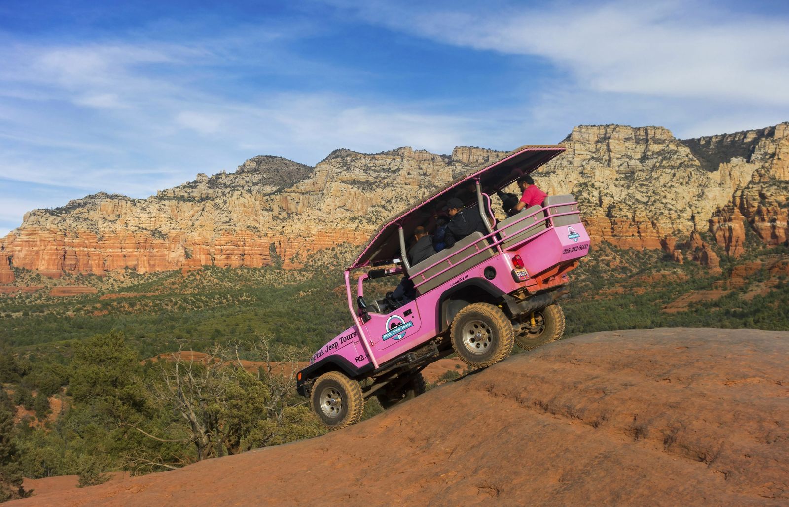 Pink jeep going over ledge - Things to do in Sedona