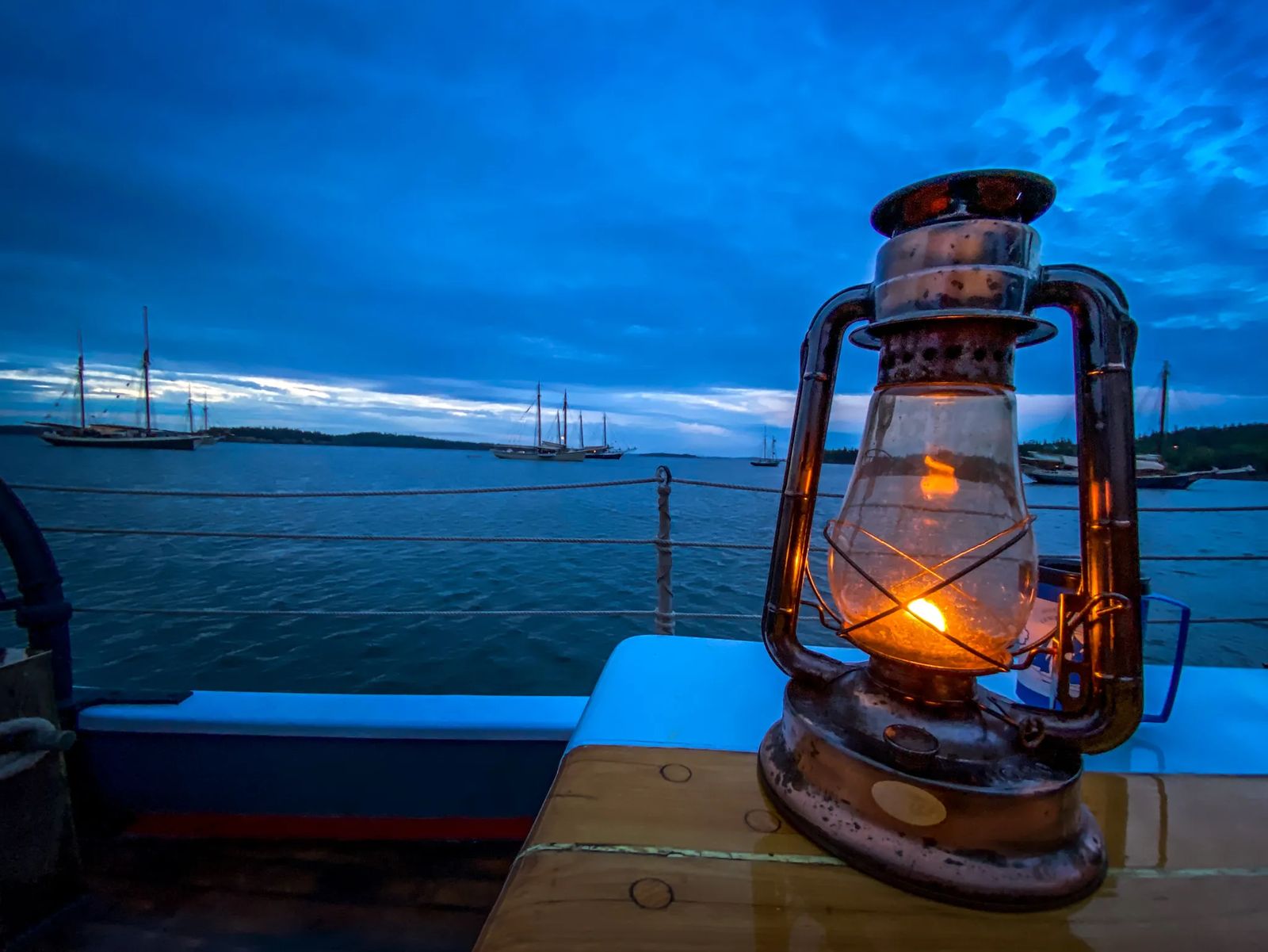 Sailing the Islands of Maine an old lantern on the ship with sail boats in the background