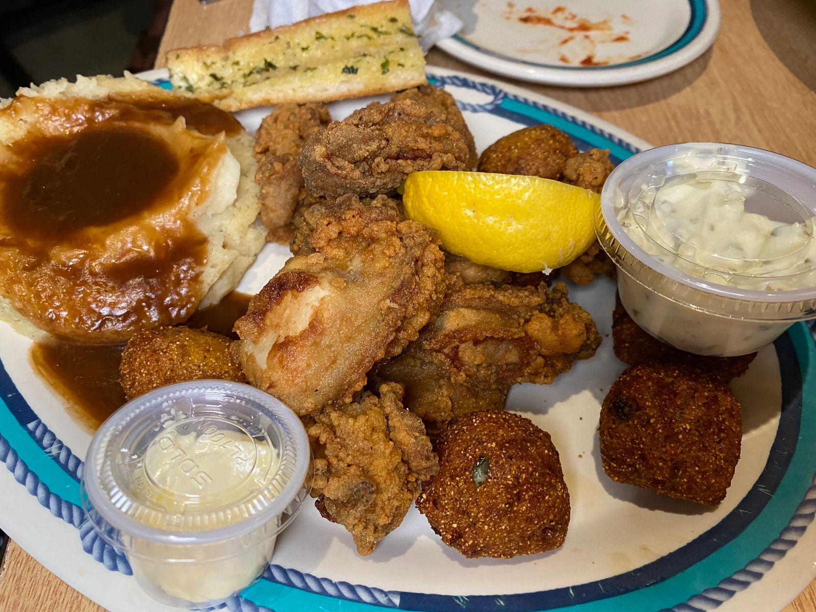 fried chicken wings with mashed potatoes and hush puppies. Best New Orleans food to eat. 