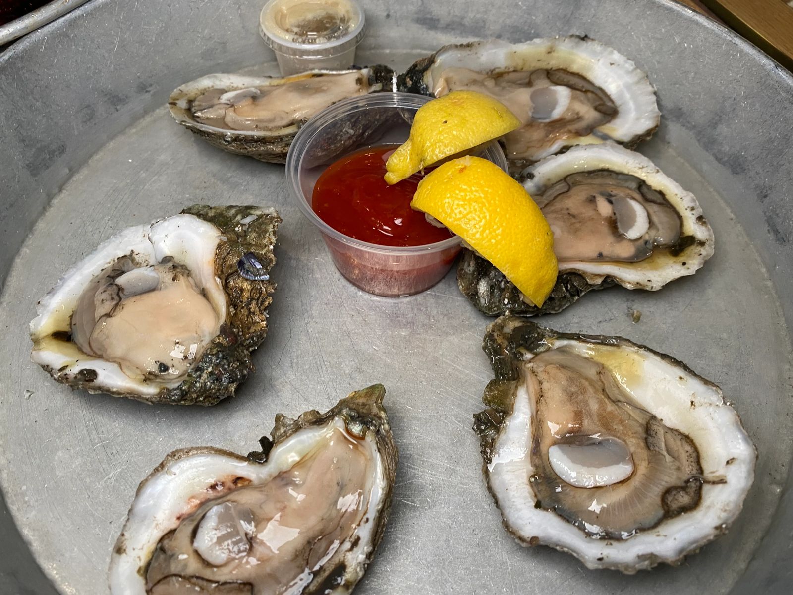 Fresh oysters with cocktail sauce and lemon best new orleans food