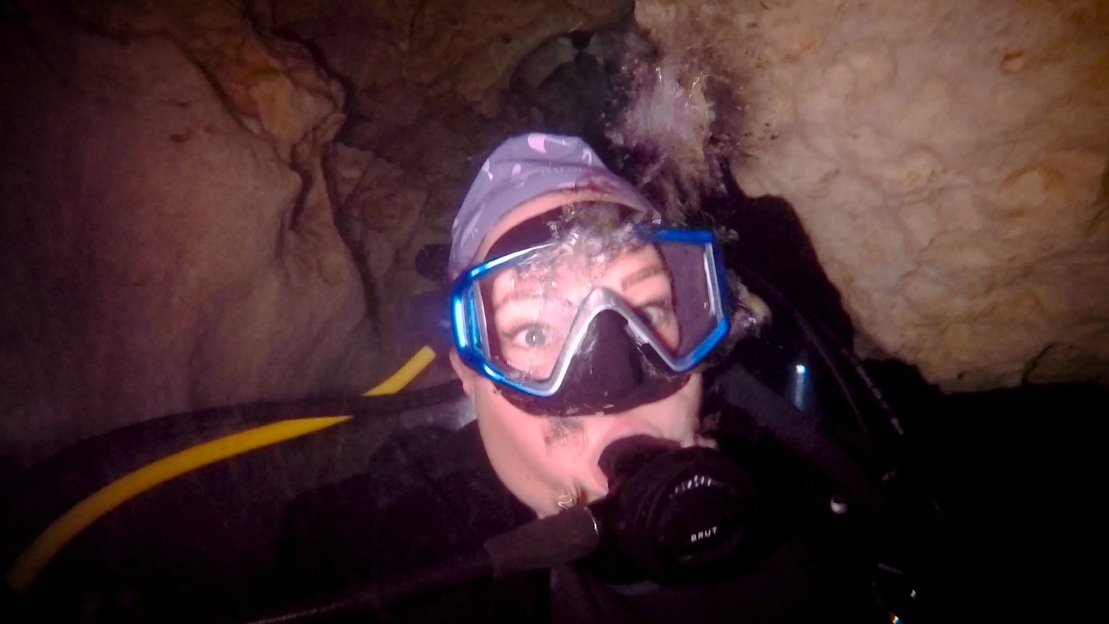 scuba diving in a cave with flashlights