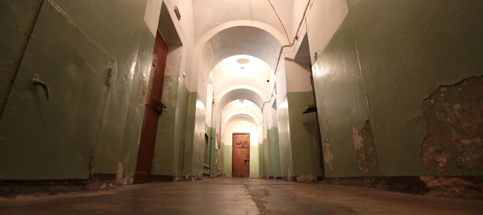 lonely derelict hallway with prison doors, best things to do in Vilnius