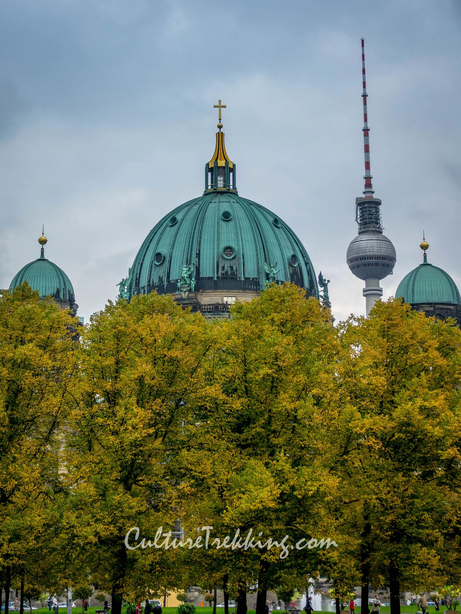 backpacking Eastern Europe 12 hours in berlin and what to see. A church steeple in green topped with a cross and a radio tower in the back