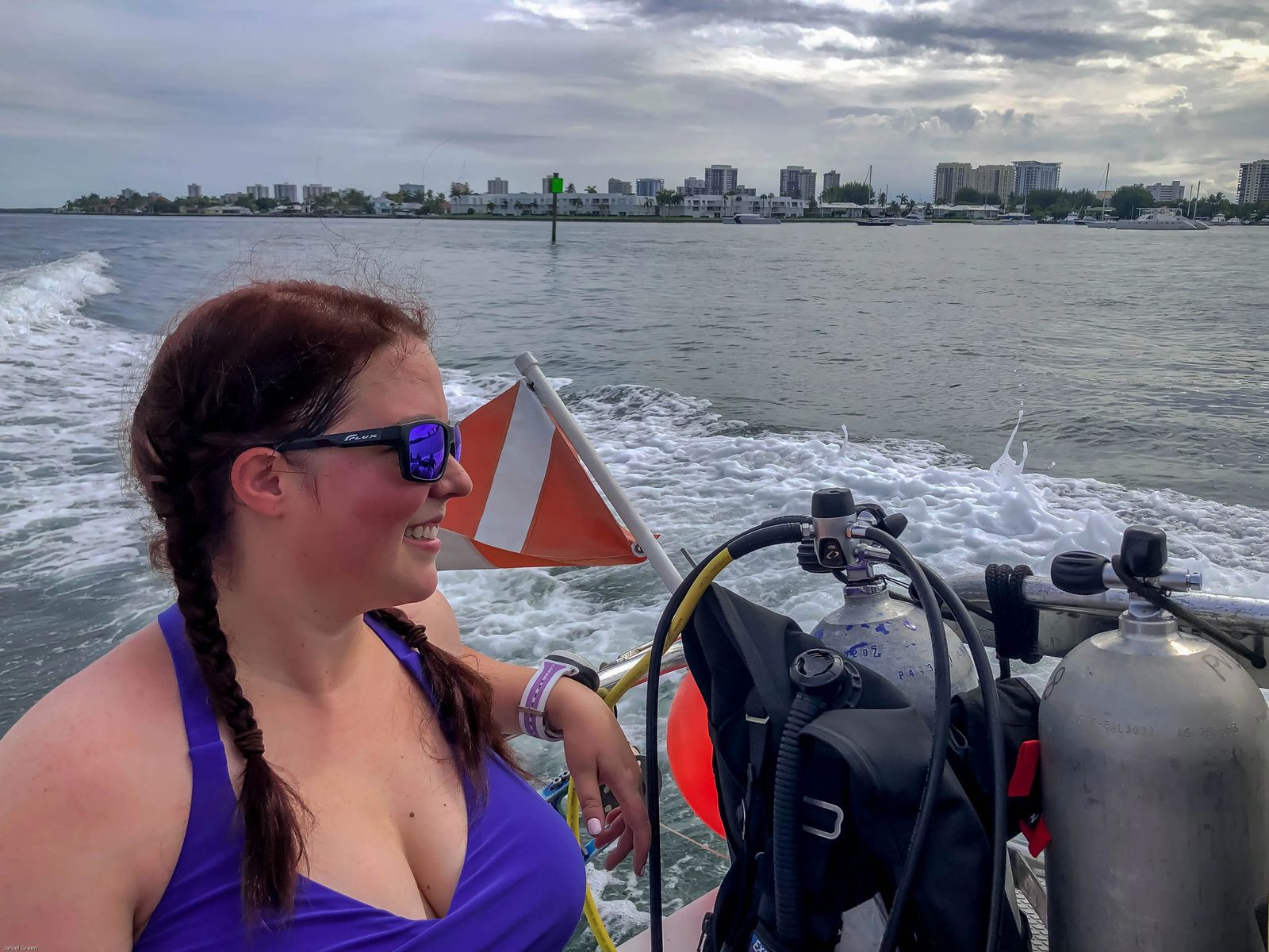 Woman sitting on a boat headed to Scuba dive off singer island in florida