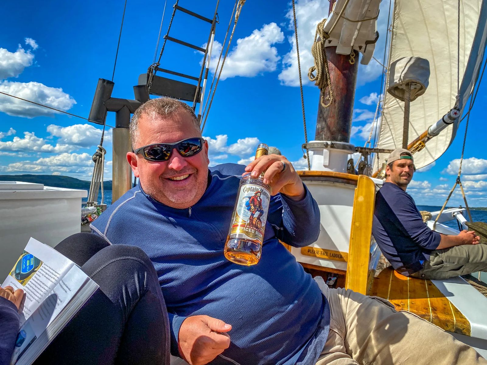 Sailing the Islands of Maine with a passenger holding a Rum bottle