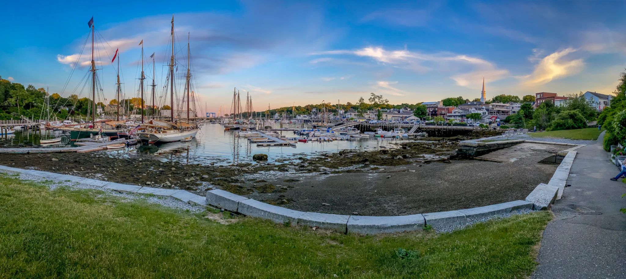 Camden Harbor with the sunset and steeple of town hall catching the last rays of sun