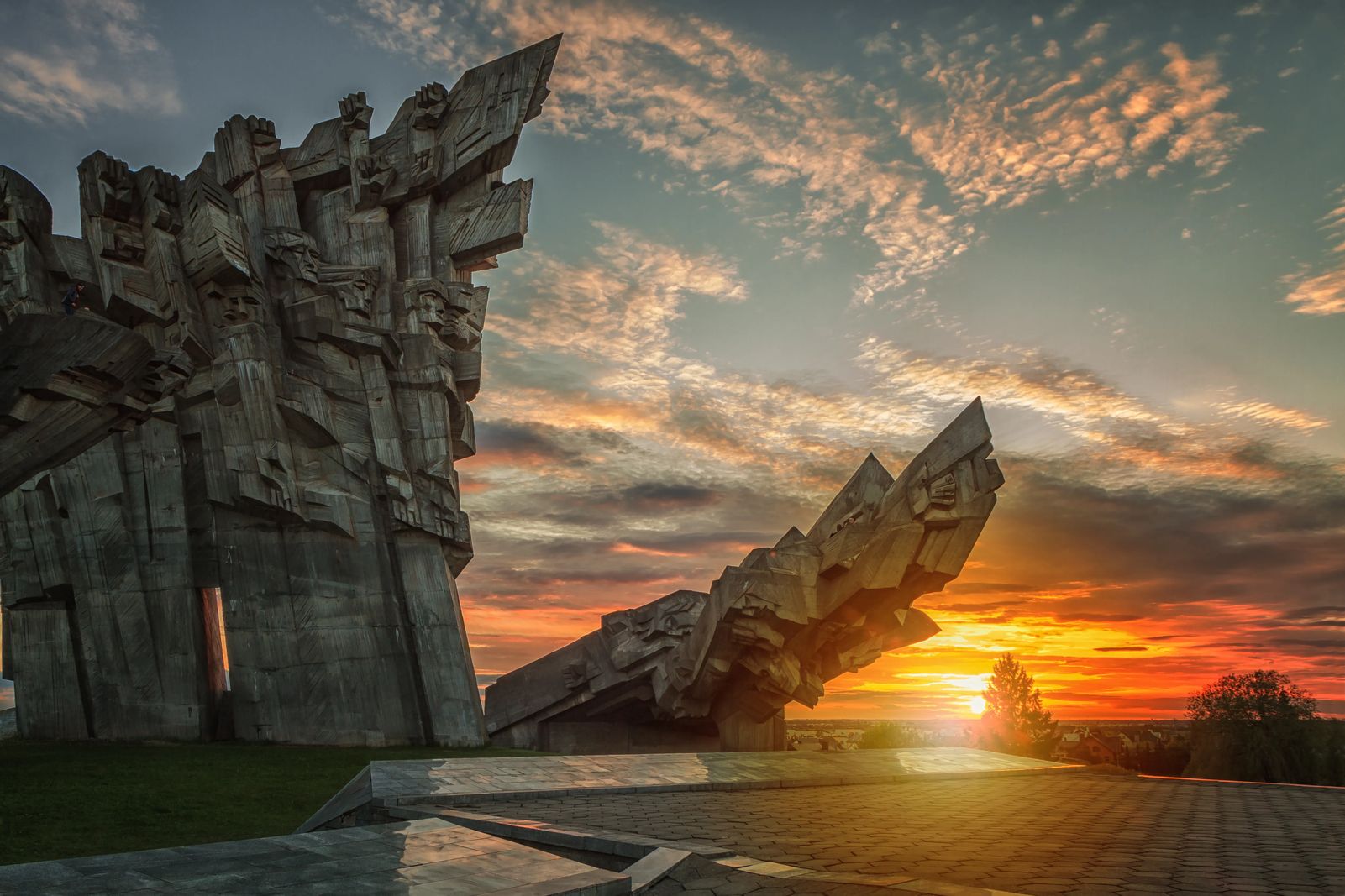 Things to do in Kaunas, Ninth fort memorial at sunset with brilliant oranges and yellows 