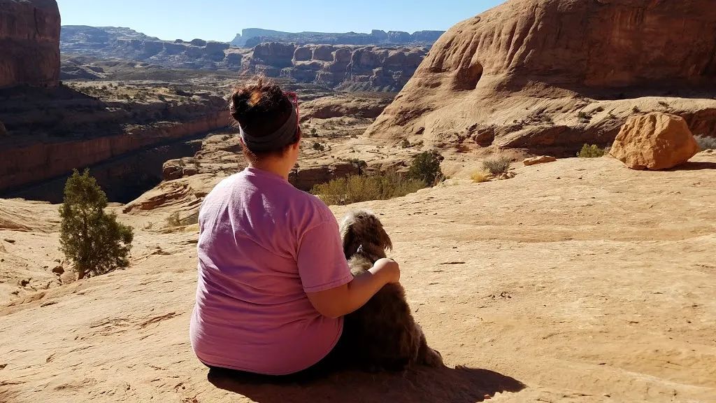 Sitting with my dog Zoey in Moab exploring southern Utah hidden gems