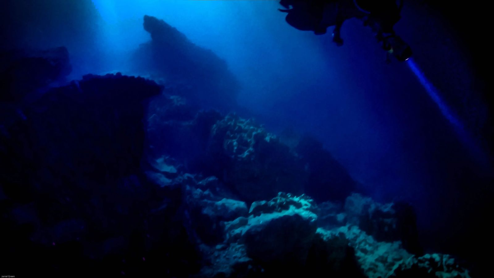 scuba diving in a cave with a flashlight